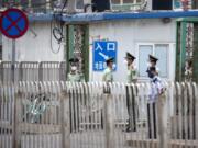 Paramilitary police stand guard on a street near the Xinfadi wholesale food market district in Beijing, Saturday, June 13, 2020. Beijing closed the city&#039;s largest wholesale food market Saturday after the discovery of seven cases of the new coronavirus in the previous two days.