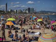 FILE - In this Saturday, June 13, 2020 file photo, people enjoy the warm weather on the beach in Barcelona, Spain. European Union envoys are close to finalizing a list of countries whose citizens will be allowed back into Europe once it begins lifting coronavirus-linked restrictions. The United States appears almost certain not to make the list, as new infections surge and given that President Donald Trump has imposed a ban on European travelers.