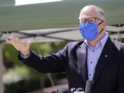 Washington Gov. Jay Inslee motions about the high rate of coronavirus cases in the area during a news conference at Yakima Valley College Tuesday, June 16, 2020, in Yakima, Wash. Inslee met with leaders in local government, health care and business to discuss the impact of the COVID-19 pandemic in the area, which has one of the highest rates of infection in the state.