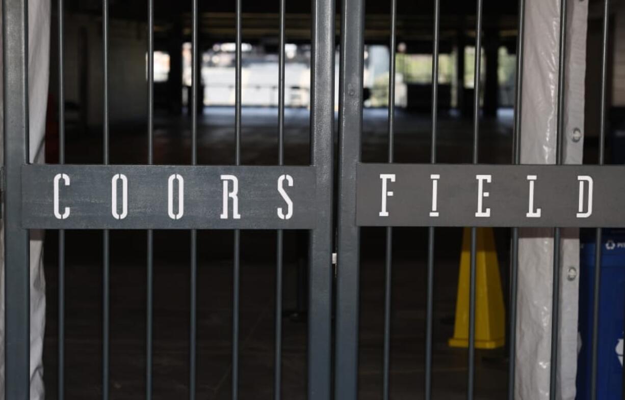 The main gate of Coors Field, home of the Major League Baseball team the Colorado Rockies, is locked early Tuesday, June 23, 2020, in Denver. The league is waiting for the players&#039; union to respond Tuesday to whether it will agree to health protocols for a 60-game regular-season slate and if players will report for training camp by July 1.