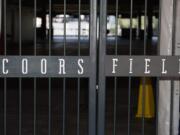 The main gate of Coors Field, home of the Major League Baseball team the Colorado Rockies, is locked early Tuesday, June 23, 2020, in Denver. The league is waiting for the players&#039; union to respond Tuesday to whether it will agree to health protocols for a 60-game regular-season slate and if players will report for training camp by July 1.