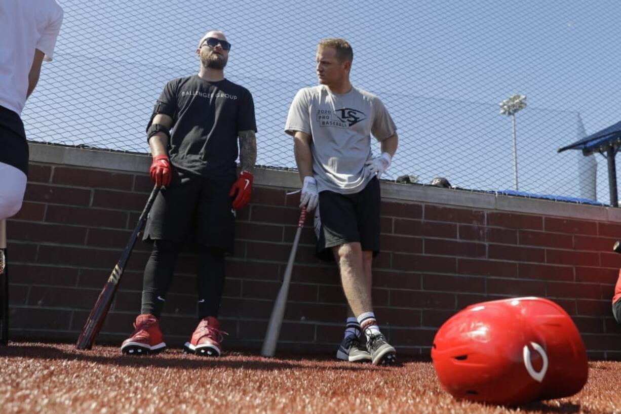 Cincinnati Reds&#039; Tucker Barnhart, left, talks with Josh VanMeter during a workout at Grand Park, Friday, June 12, 2020, in Westfield, Ind. Proceeds from the event will go to Reviving Baseball in the Inner City of Indianapolis.