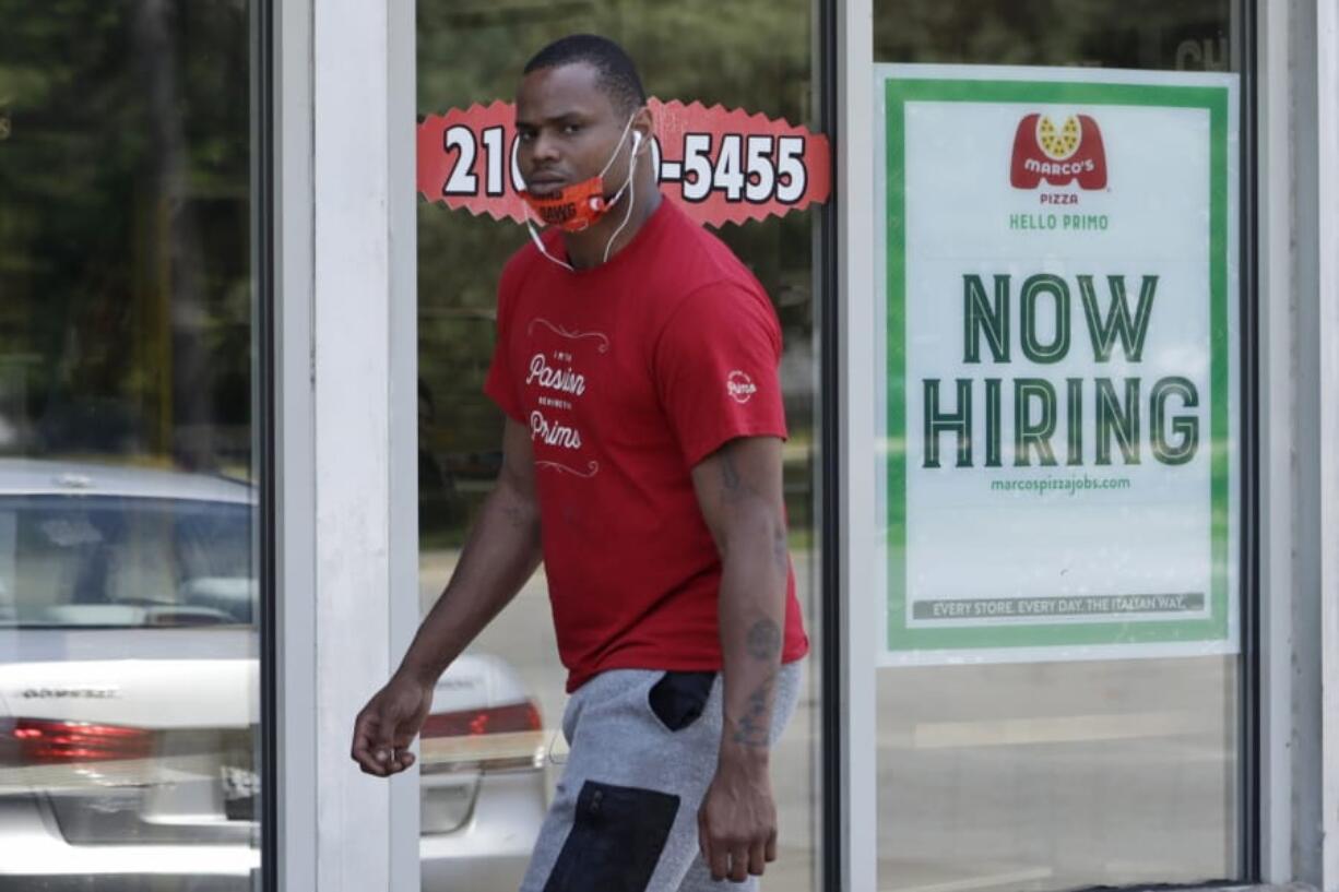 A man walks past Marco&#039;s Pizza, which is now hiring, Friday, June 5, 2020, in Euclid, Ohio. U.S. unemployment dropped unexpectedly in May to 13.3% as reopened businesses began recalling millions of workers faster than economists had predicted, triggering a rally Friday on Wall Street.