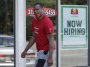 A man walks past Marco&#039;s Pizza, which is now hiring, Friday, June 5, 2020, in Euclid, Ohio. U.S. unemployment dropped unexpectedly in May to 13.3% as reopened businesses began recalling millions of workers faster than economists had predicted, triggering a rally Friday on Wall Street.