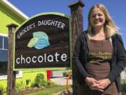 In this June 11, 2020 photo, Jody Hayden poses at the Grocer&#039;s Daughter chocolate shop which she owns with her husband in Empire, Mich, She said her family wears masks and keep their distance from others -- and will expect their customers to do the same when they open the doors to their shop, next Friday, June. 19. Even as states and metropolitan areas relax restrictions on social and economic life amid the ongoing coronavirus pandemic, a new poll finds that most Americans aren&#039;t ready to abandon behaviors that protect themselves and the people around them.