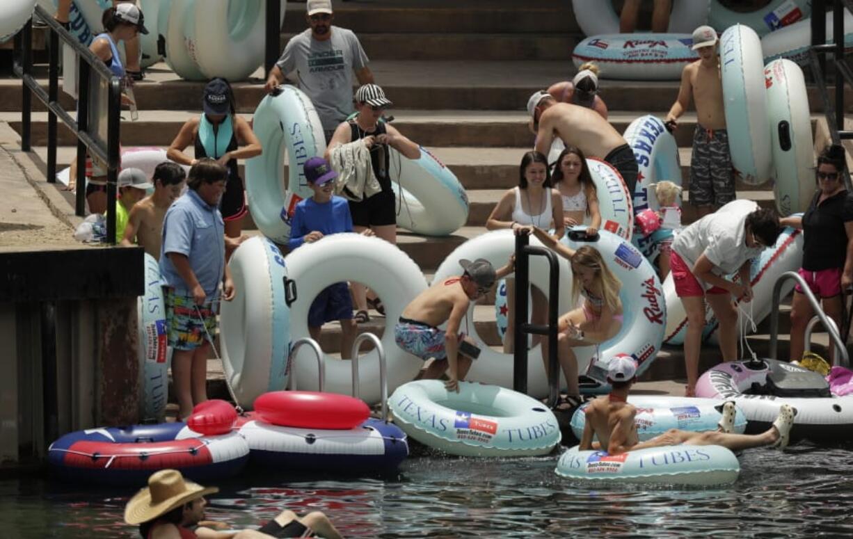 Tubers prepare to float the Comal River despite the recent spike in COVID-19 cases, Thursday, June 25, 2020, in New Braunfels, Texas. Texas Gov. Greg Abbott said Wednesday that the state is facing a &quot;massive outbreak&quot; in the coronavirus pandemic and that some new local restrictions may be needed to protect hospital space for new patients.