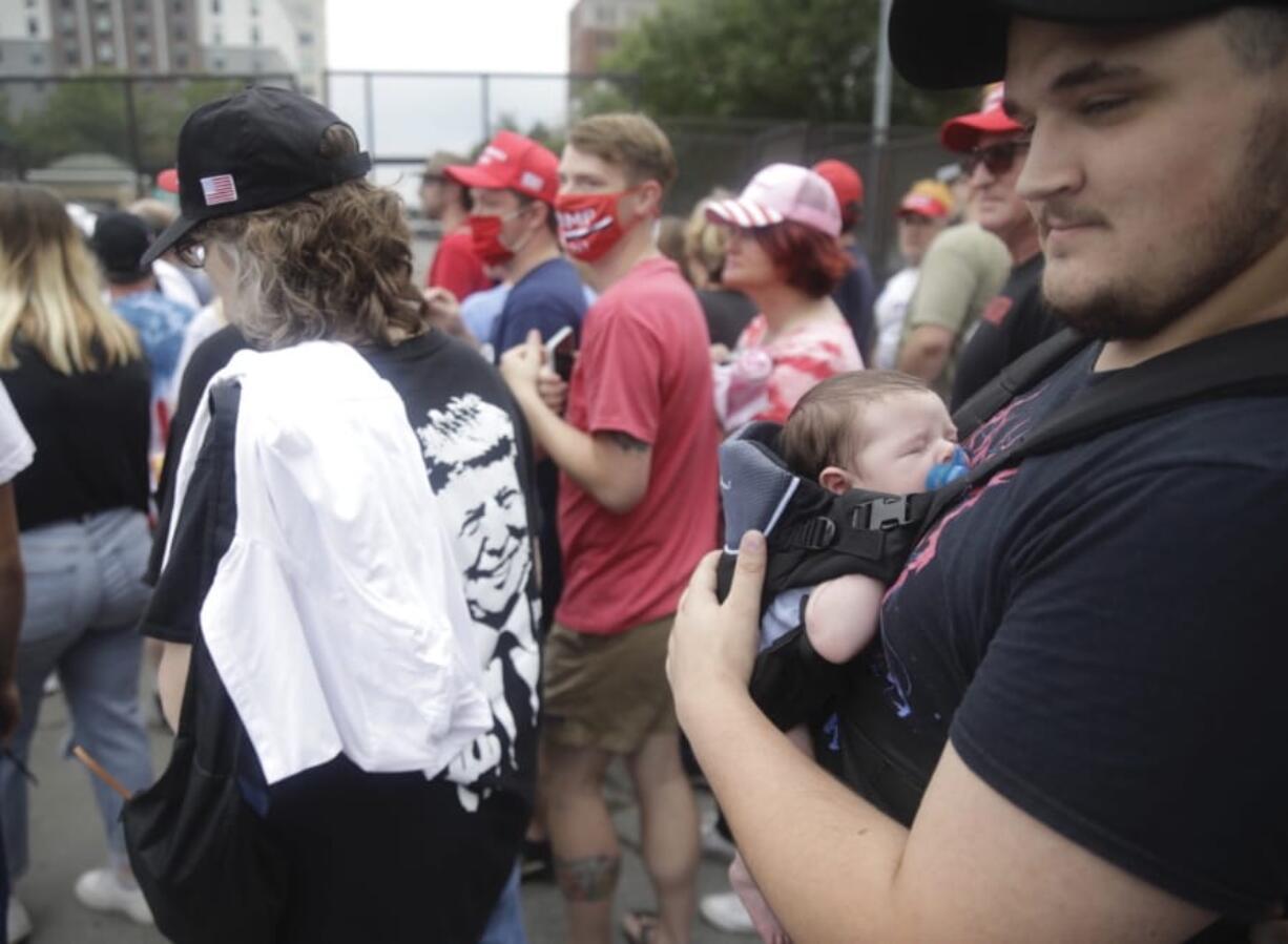 Jacob Osborne and his son Phoenix, enter as safety barricade gates are opened for supporters to enter for  President Donald Trump&#039;s campaign rally on Saturday, June 20, 2020 in Tulsa, Oka.