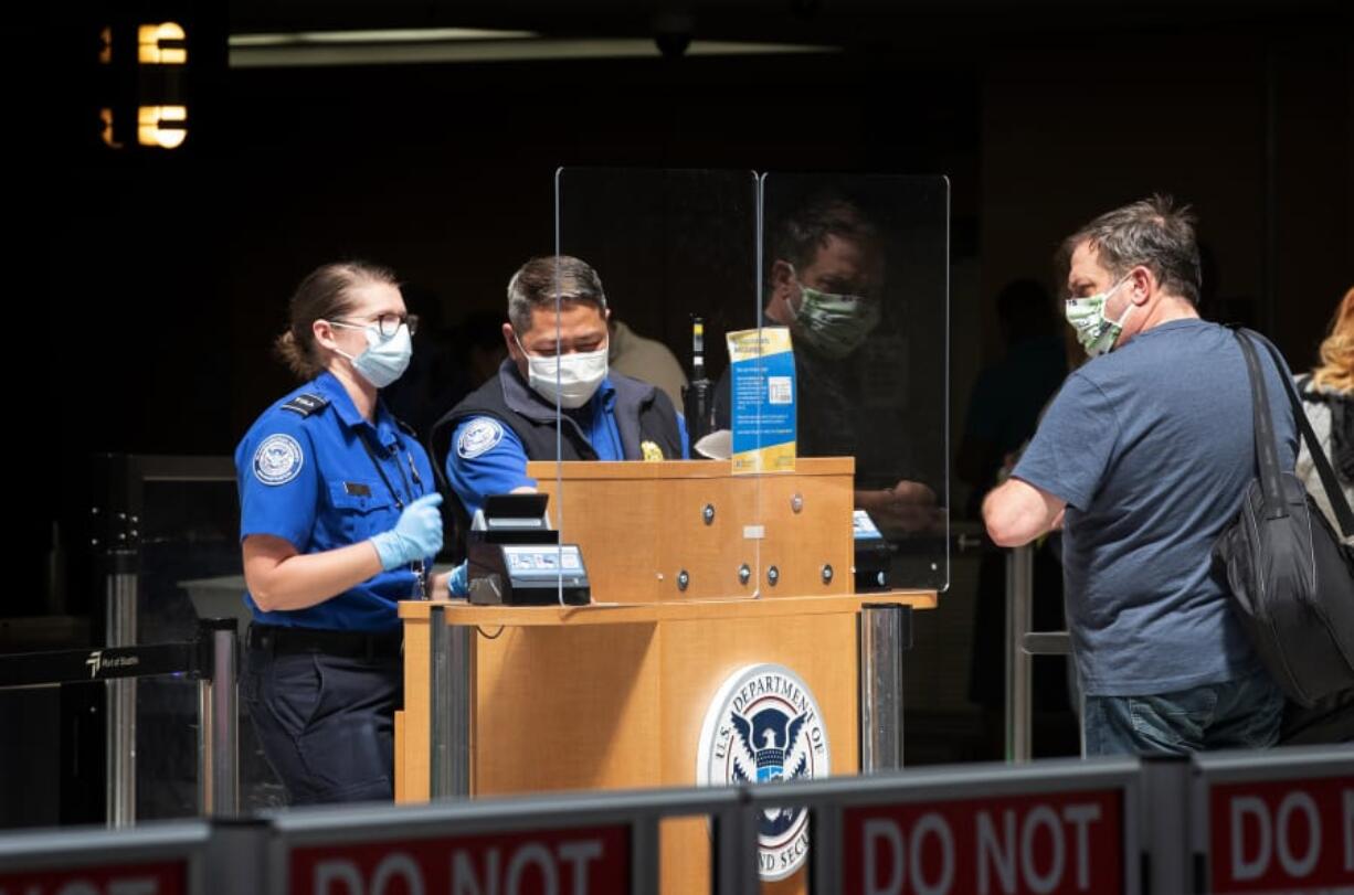 A passenger goes through a security checkpoint at Sea-Tac International Airport on May 15. (Ellen M.