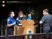 A passenger goes through a security checkpoint at Sea-Tac International Airport on May 15. (Ellen M.