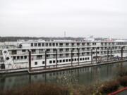 An American Cruise Line ship is pictured on the Columbia River next to the Jantzen Beach Red Lion in Portland on March 22, 2019. American Cruise Lines will dock three mostly empty river cruise ships in Astoria, Ore., beginning Thursday to wait out coronavirus restrictions.