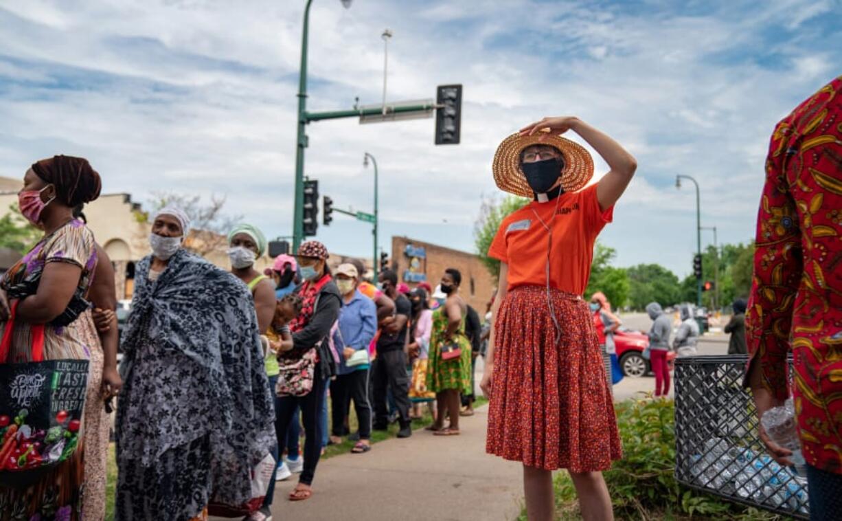 Lutheran minister Bethany Ringdal is one of the volunteer chaplains helping at Holy Trinity Lutheran Church, which has been a major food distribution site since Lake Street burned. She kept a lookout for anyone who needed help or just a bottle of water on June 26.