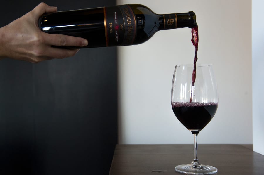 Heidi Griggs, manager of the joint Pepper Bridge Winery and Amavi Cellars tasting room, pours a glass in November 2020 at the tasting room on the ground floor of the Rediviva building. Two more wineries are set to join the lineup at The Waterfront.