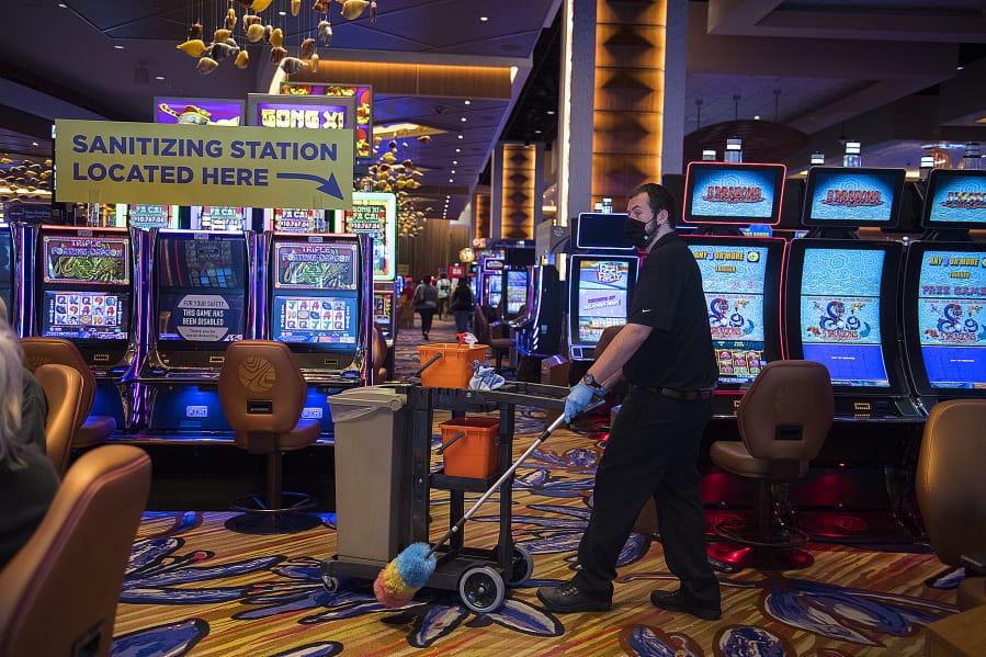 Lars Winger of ilani lends a hand as the staff works to keep things clean during the casino&#039;s reopening. The casino opened two phases before the wishes of Gov. Jay Inslee. Since the casino complex is owned by the Cowlitz Tribe, the casino does not have to follow Washington&#039;s reopening plan.