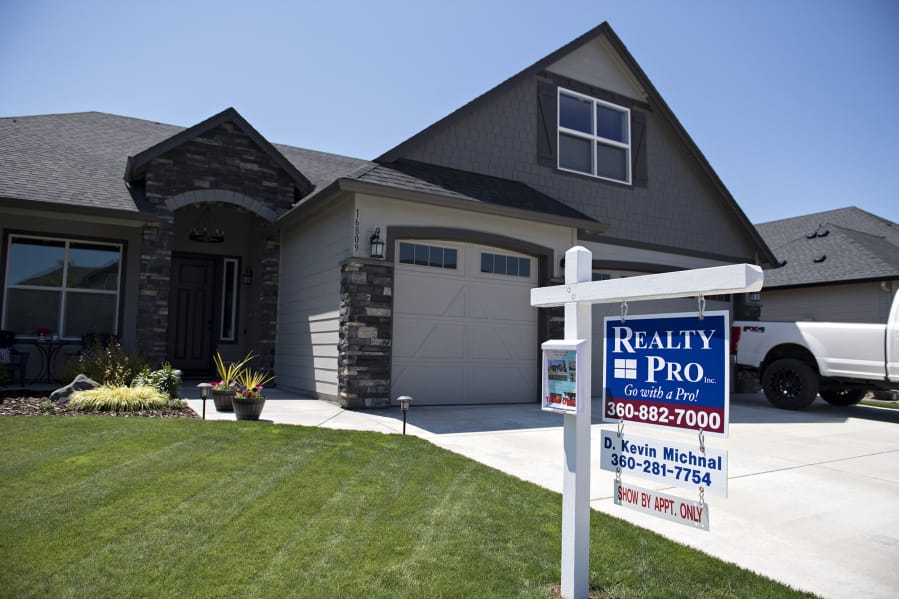 A sign advertises a house for sale in northeast Vancouver  in July.