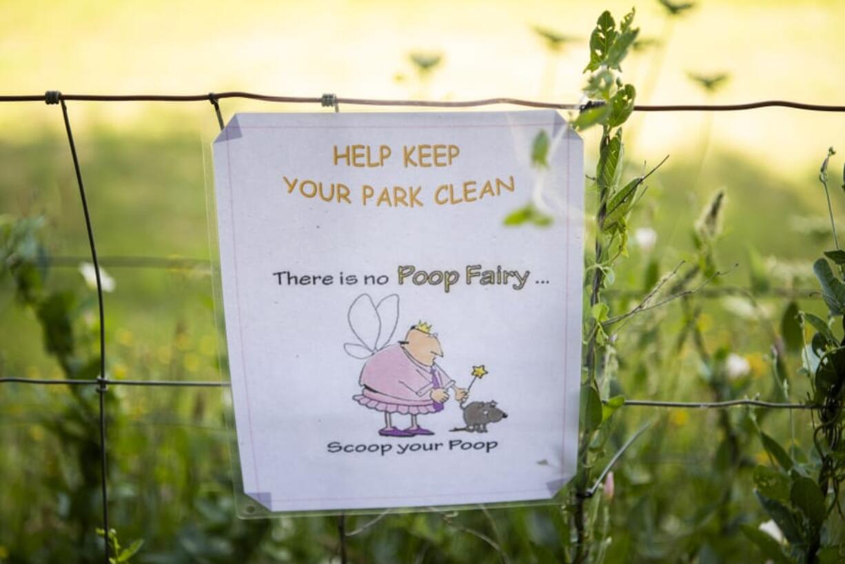 Signs are posted around Ike Dog Park to remind people to pick up after their dogs.