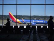 Travelers at Gate E10 wait to board a Southwest plane in the new Concourse E extension at Portland International Airport.