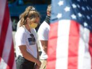 McKenna Babikoff of Battle Ground prays during a rally supporting police at Esther Short Park in downtown Vancouver on Saturday. The rally was part of a national movement called Bridge the Blue.