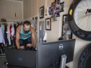 Joshua Monda demonstrates how he virtually rides his bike through London in the garage of his Vancouver home Wednesday afternoon, July 22, 2020.