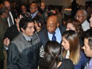 U.S. Rep. John Lewis, the civil rights icon, was a surprise special guest at the 2014 Martin Luther King Jr. Breakfast at Clark College. Here he greets youths with the local League of United Latin American Citizens.