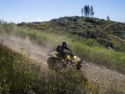 Jess Shutts of Vancouver rides an ATV on Saturday in the Jones Creek Trail System in the Yacolt Burn State Forest.