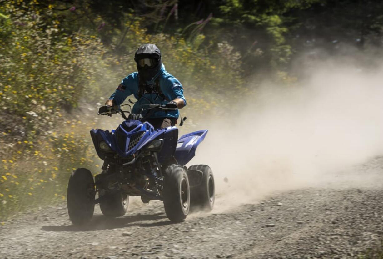 Gregg Shutts of Vancouver heads down a gravel road to find a trailhead in the Jones Creek Trail System in the Yacolt Burn State Forest on Saturday.