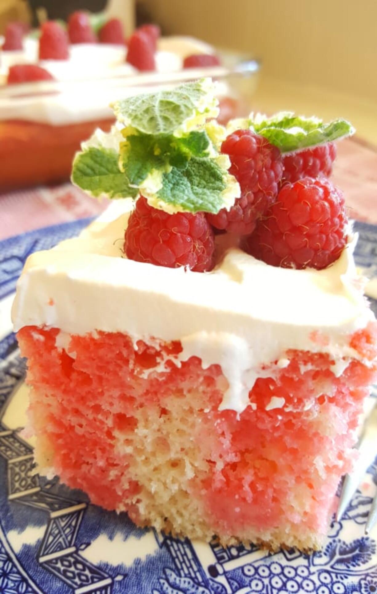 This raspberry poke cake has pockets of raspberry flavor made by poking holes in the cake while it&#039;s still warm and filling them with raspberry gelatin.
