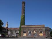 Members of The Historic Trust decided to give up hope of preserving the historic smokestack and boiler building, right, at the Providence Academy, because they couldn't justify the high costs.