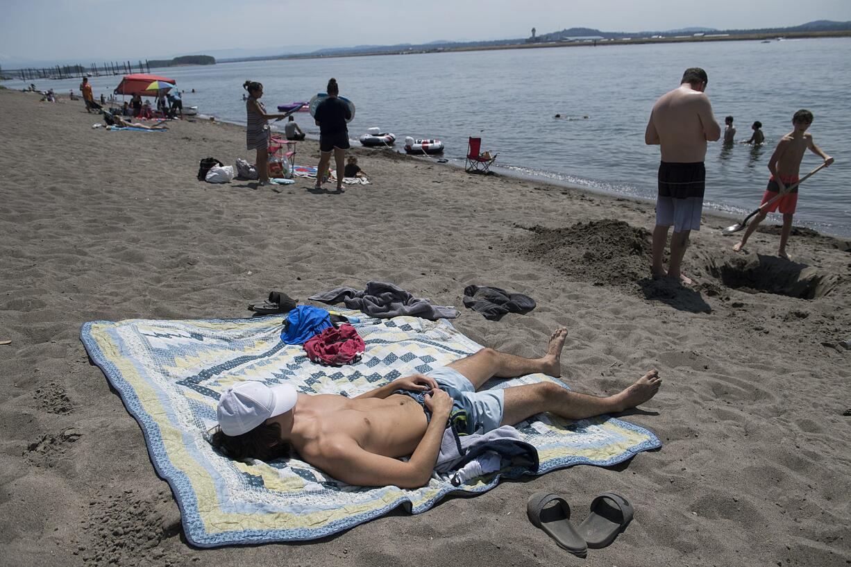 With recent temperatures nearing 100 degrees, area residents flocked to their favorite swimming holes Sunday and Monday to beat the heat. Sunday was the first 100-degree day in Vancouver in three years. Despite the crowds, Vancouver’s Calvin Clark, 17, kept social distancing in mind as he basked in the sunshine while joining his family Monday afternoon at Wintler Park. By noon, a sign notified beachgoers that the parking lot was full. Temperatures in Clark County are forecast to be slightly cooler, but to remain in the 80s and 90s for the rest of the week.