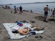 With recent temperatures nearing 100 degrees, area residents flocked to their favorite swimming holes Sunday and Monday to beat the heat. Sunday was the first 100-degree day in Vancouver in three years. Despite the crowds, Vancouver’s Calvin Clark, 17, kept social distancing in mind as he basked in the sunshine while joining his family Monday afternoon at Wintler Park. By noon, a sign notified beachgoers that the parking lot was full. Temperatures in Clark County are forecast to be slightly cooler, but to remain in the 80s and 90s for the rest of the week.