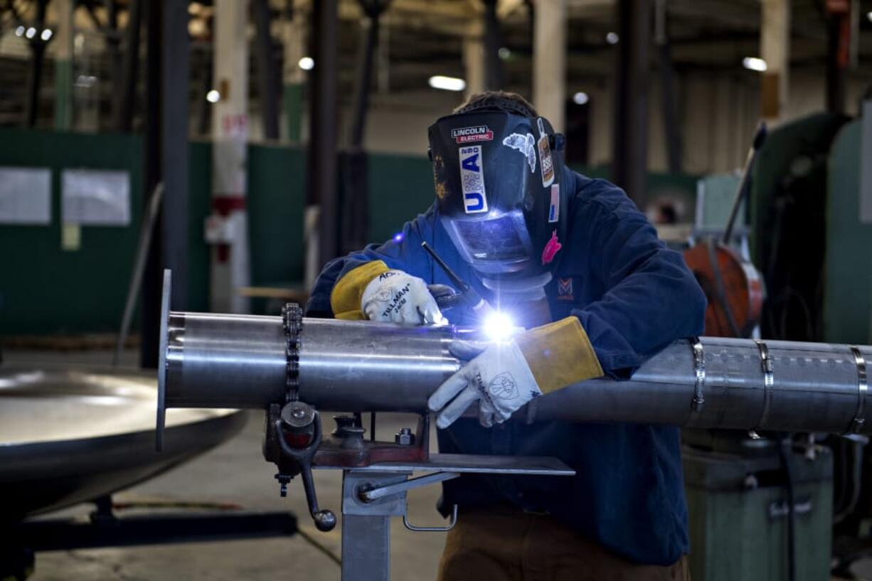 LEADOPTION Andrew Muth, 37, of Marks Design &amp; Metalworks, builds a filter for a methane tank while joining colleagues at work on a recent weekday. Muth lost two fingers on his left hand after an accident in a high school shop class. &quot;I had to try a lot harder than a lot of people to learn how to weld because I don&#039;t have all my fingers,&quot; he said.