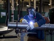 LEADOPTION Andrew Muth, 37, of Marks Design &amp; Metalworks, builds a filter for a methane tank while joining colleagues at work on a recent weekday. Muth lost two fingers on his left hand after an accident in a high school shop class. &quot;I had to try a lot harder than a lot of people to learn how to weld because I don&#039;t have all my fingers,&quot; he said.