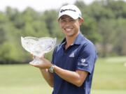 Collin Morikawa holds his trophy after winning the Workday Charity Open golf tournament, Sunday, July 12, 2020, in Dublin, Ohio.