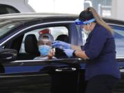 A health care worker takes information from a person at a Covid-19 testing center on Tuesday, July 21, 2020, in Pleasanton, Calif.