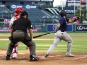 Seattle Mariners' Jose Marmolejos, right, hits a three-run home run as Los Angeles Angels catcher Max Stassi, left, watches along with home plate umpire Doug Eddings during the first inning of a baseball game Thursday, July 30, 2020, in Anaheim, Calif. (AP Photo/Mark J.