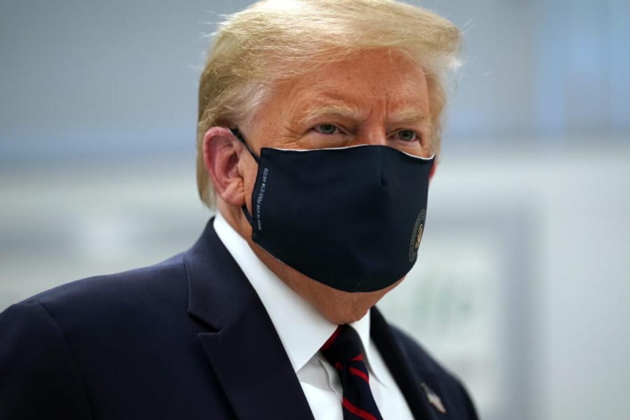 President Donald Trump wears a face mask as he participates in a tour of Bioprocess Innovation Center at Fujifilm Diosynth Biotechnologies, Monday, July 27, 2020, in Morrisville, N.C.