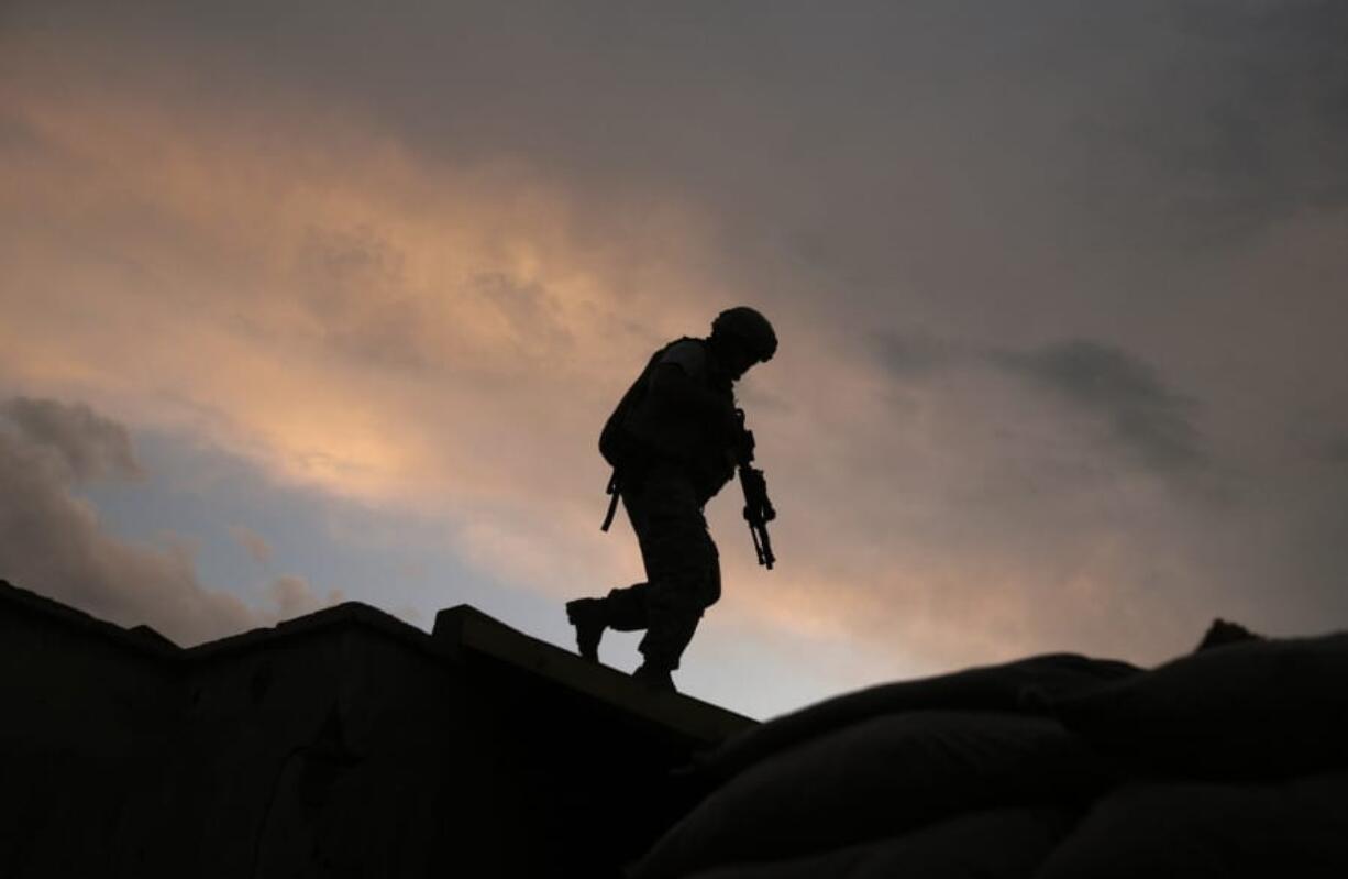 FILE -  In this Sept. 18, 2009, file, photo, A soldier from the U.S. Army&#039;s 118th Military Police Co., based at Fort Bragg, N.C., respond to shots fired at a combat outpost in the Jalrez Valley in Afghanistan&#039;s Wardak Province.  Moscow and Washington are intertwined in a complex and bloody history in Afghanistan, with both suffering thousands of dead and wounded in conflicts lasting for years. Now both superpowers are linked again over Afghanistan, with intelligence reports indicating Russia secretly offered bounties to the Taliban to kill American troops there. But analysts suggest that the two adversaries actually have more in common, especially when it comes to what they want to see in a postwar Afghanistan: a stable country that does not serve as a base for extremists to export terrorism.