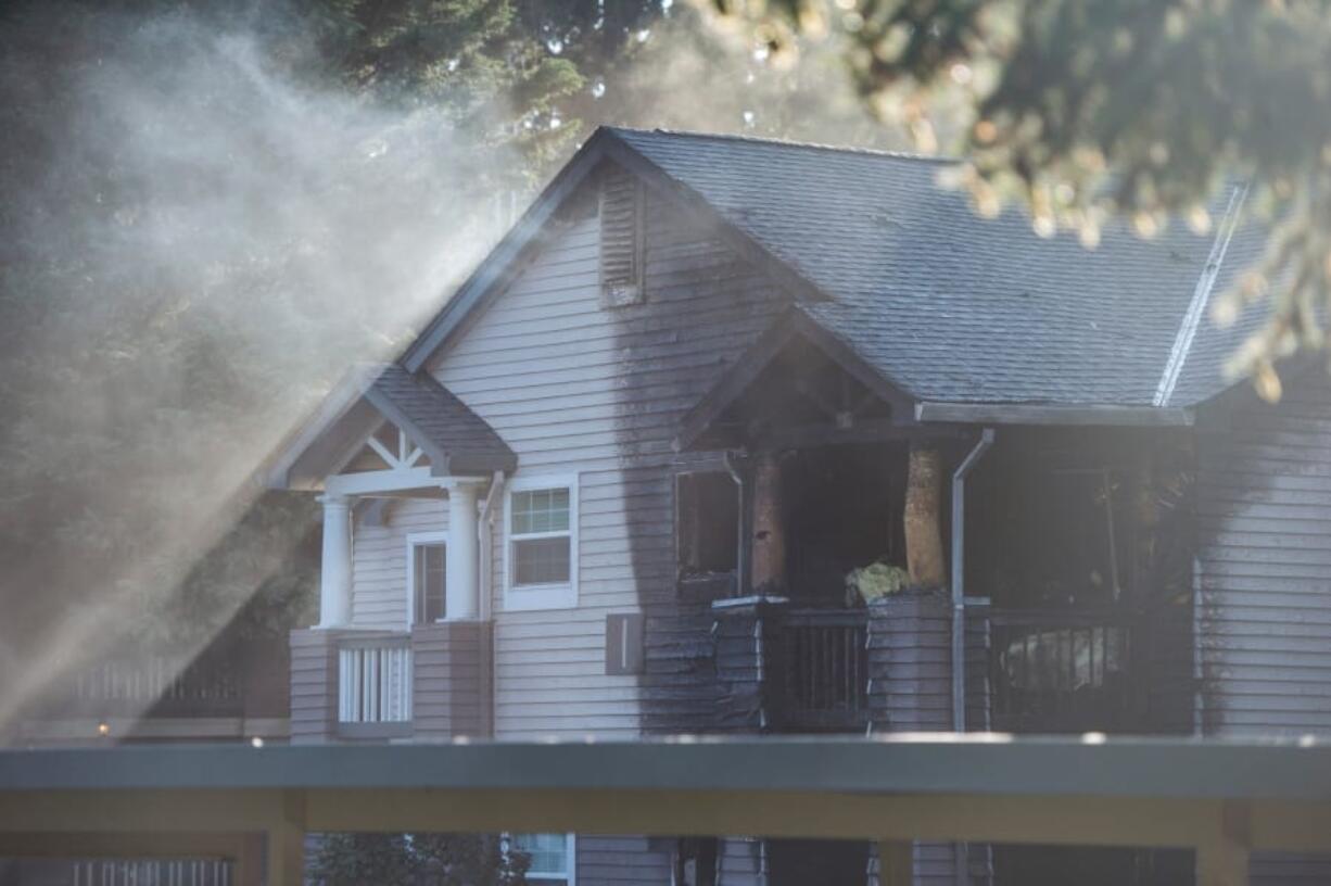 Burn marks show the extent of a fire at the Autumn Chase Apartments in Vancouver on Wednesday evening. Four people were injured in the fire.