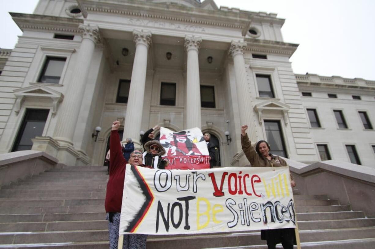 FILE - Protesters hold banners on the steps of the South Dakota Capitol in Pierre in a Tuesday, Feb. 18, 2020 file photo.Iowa, South Carolina and South Dakota recently joined Nebraska in agreeing to share driver&#039;s license information with the U.S. Census Bureau to help the Trump administration with the controversial task of figuring out the citizenship status of every U.S. resident.