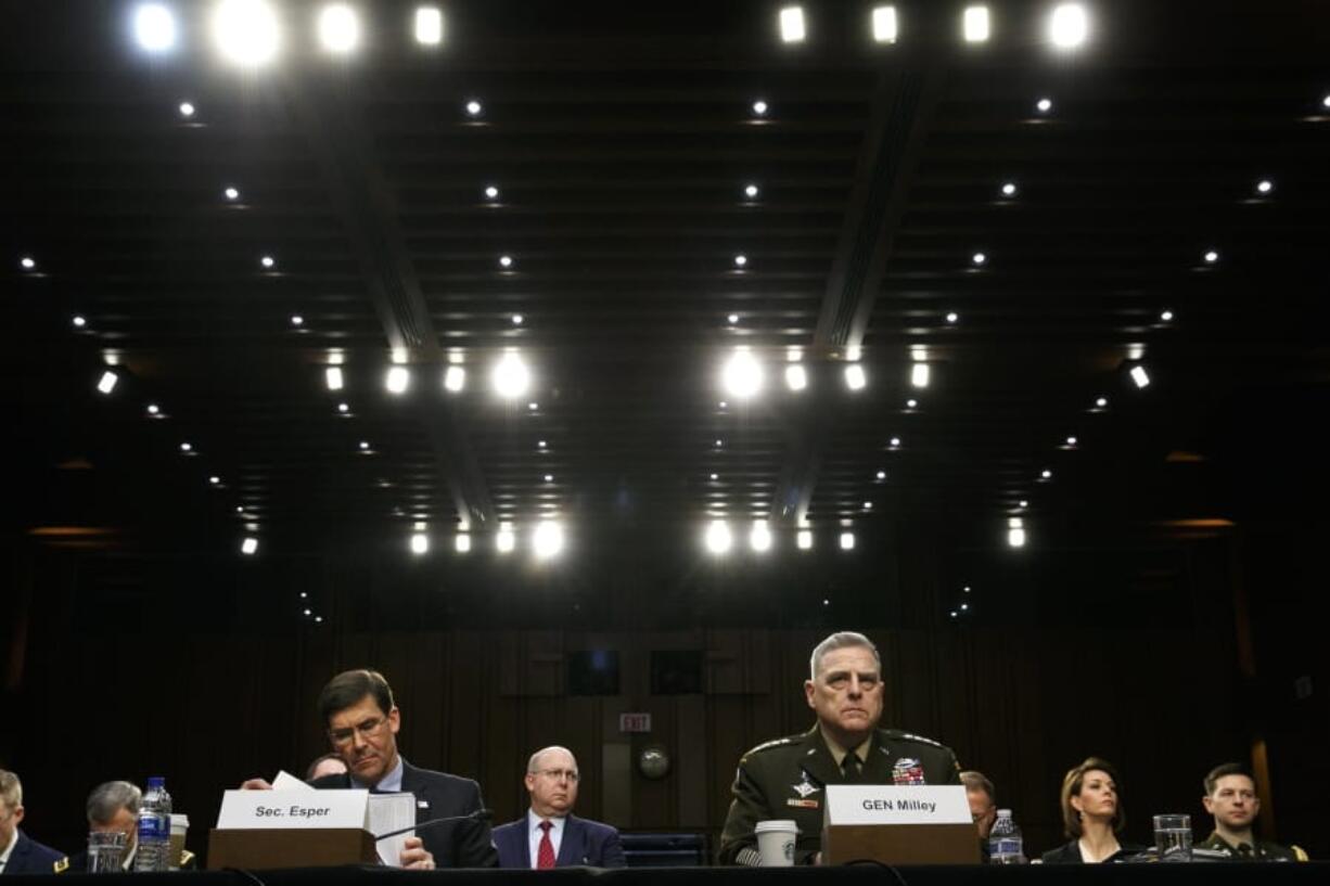 FILE - In this March 4, 2020, file photo Defense Secretary Mark Esper, left, and Chairman of the Joint Chiefs of Staff Gen. Mark Milley, listen during a Senate Armed Services Committee on budget posture on Capitol Hill in Washington. Esper and Milley are going before Congress for the first time in months to face a long list of controversies, including their differences with President Donald Trump over the handling of protests near the White House last month during unrest triggered by the killing George Floyd in police hands.