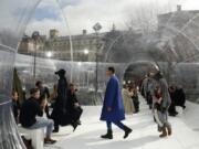 FILE - In this Feb. 26, 2020 file photo, models wear creations for the Kenzo fashion collection during Women&#039;s fashion week Fall/Winter 2020/21 presented in Paris. The coronavirus pandemic has instilled extra unpredictability into the already fickle Paris Fashion Week. After first canceling the July shows for menswear and Haute Couture, the French fashion federation has now organized an unprecedented schedule of digital-only events instead.