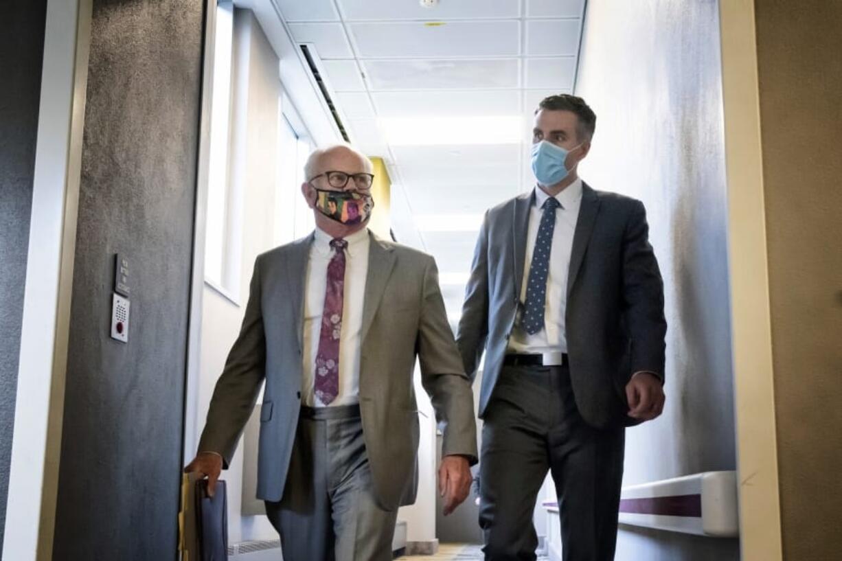 Former Minneapolis police officer Thomas Lane, right, walks out of the Hennepin County Public Safety Facility on Monday afternoon June 20, 2020, in Minneapolis with his attorney, Earl Gray, after a hearing. Lane is one of four former officers charged in the death of George Floyd.