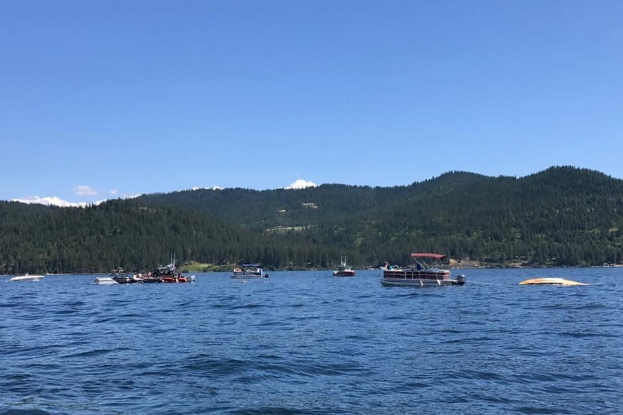 Boaters flag down authorities to a crashed seaplane near Powderhorn Bay on Lake Coeur d&#039;Alene on Sunday, July 5, 2020, south of Coeur d&#039;Alene, Idaho. The downed plane can be seen in the right side of the image. Two people died in a plane crash Sunday over Lake Coeur d&#039;Alene Sunday, the Kootenai County Sheriff&#039;s Office told the Spokane Spokesman-Review. Investigators are checking initial reports that there were a total of eight passengers and crew on the two planes, the sheriff&#039;s office said in a statement Sunday night.