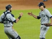 Seattle Mariners relief pitcher Taylor Williams, right, celebrates with catcher Austin Nola after a baseball game against the Houston Astros Sunday, July 26, 2020, in Houston. The Mariners won 7-6. (AP Photo/David J.