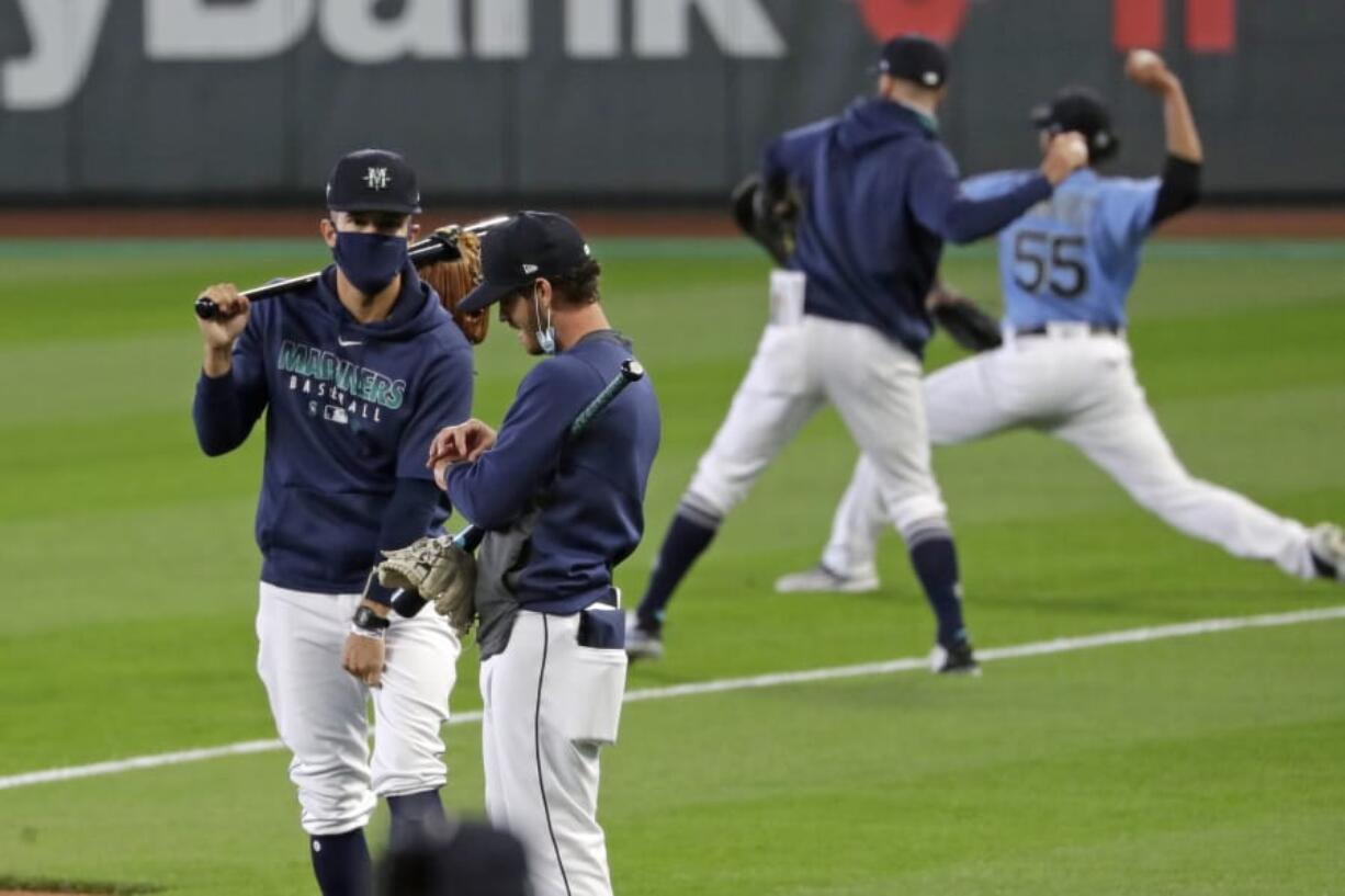 Seattle Mariners players and coaches begin a &quot;summer camp&quot; baseball workout on their ballpark field Friday, July 3, 2020, in Seattle.