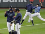 Seattle Mariners players and coaches begin a &quot;summer camp&quot; baseball workout on their ballpark field Friday, July 3, 2020, in Seattle.