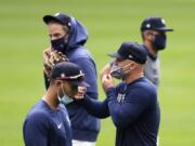 Seattle Mariners&#039; Kyle Seager, second right, and teammates wear masks as they walk on the field at baseball practice Tuesday, July 7, 2020, in Seattle.