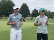 Mountain View's Graham Moody, left, poses with his championship trophy after winning the Oregon Junior Amateur on Friday at the OGA Golf Course in Woodburn. He beat Nicholas Watts of Springfield, right, 3 and 2.