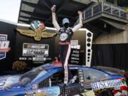 Race driver Kevin Harvick celebrates after winning the NASCAR Cup Series auto race at Indianapolis Motor Speedway in Indianapolis, Sunday, July 5, 2020.