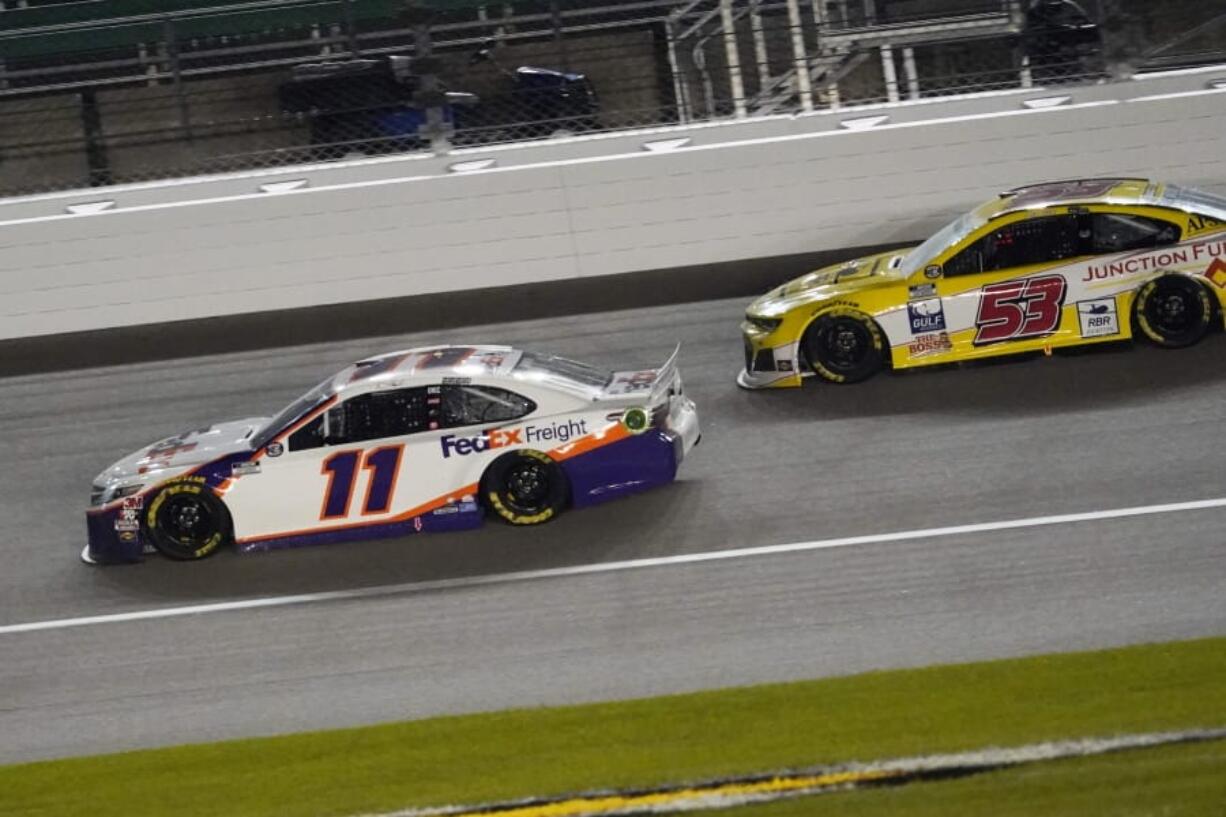 Denny Hamlin (11) battles Josh Bilicki (53) during a NASCAR Cup Series auto race at Kansas Speedway in Kansas City, Kan., Thursday, July 23, 2020.