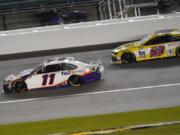 Denny Hamlin (11) battles Josh Bilicki (53) during a NASCAR Cup Series auto race at Kansas Speedway in Kansas City, Kan., Thursday, July 23, 2020.